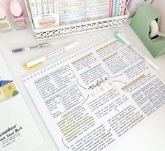 a desk with some pens and paper on it