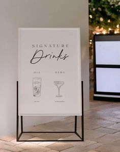 a sign that says signature drinks and two glasses next to each other on the floor