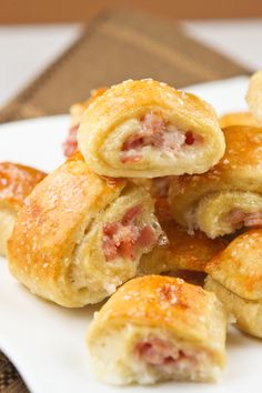 ham and cheese pastry rolls on a white plate