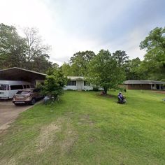 two cars parked in front of a house on the side of a road next to trees