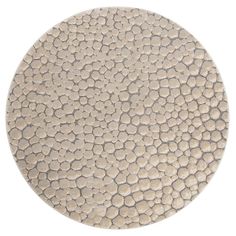 a beige and white circular rug with circles on it