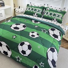 a soccer themed comforter set with stars and balls on the green striped bedding