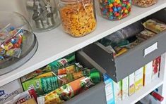 the shelves are filled with different types of snacks and candy in plastic containers on top of them