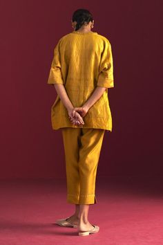 Ochre kaftan top with floral brocade woven motifs and embroidered neckline. Paired with cotton silk pant.
Components: 2
Pattern: Woven
Type Of Work: Floral
Neckline: V neck
Sleeve Type: Half sleeves
Fabric: Brocade, Handloom Tissue, Cotton Silk, Lining: Shantoon
Color: Yellow
Other Details: 
Disclaimer: Since all our products are sustainable, touched by human hands be it weaving, block printing, or embroidery, there might be slight imperfections that make them unique and individual.
Occasion: Me Festive Dabka Embellished Tops, Traditional Dabka Tops, Raw Silk Tops With Traditional Drape, Festive Tops With Set-in Sleeves, Festive Designer Linen Sets, Linen Sets For Designer Wear At Eid, Linen Sets For Designer Wear On Eid, Linen Sets For Eid Designer Wear, Eid Designer Linen Sets