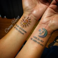 two people with matching tattoos on their arms, one has a sun and the other has a moon