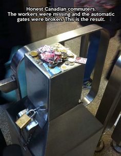 a metal trash can sitting on top of an airport floor