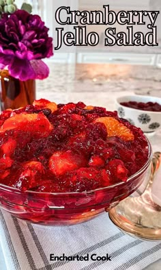 cranberry jello salad in a glass bowl on top of a white table