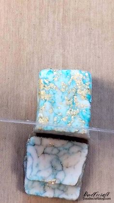 two pieces of blue and white marble sitting on top of each other next to one another