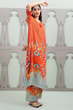 Orange asymmetric kurta with floral garden patterns and placement sequin embroidery. Comes with pant.
Components: 2
Pattern: Embroidered
Type Of Work: Floral, Sequin
Neckline: Round
Sleeve Type: Three quarter
Fabric: Crepe
Color: Orange
Other Details: 
Pintucked placket
Model Height: 5ft 10inches wearing size S
Weight: 800 grms
Occasion: Sangeet,Mehendi and Haldi - Aza Fashions Silk Sets With Printed Motifs In Maxi Length, Silk Maxi Sets With Printed Motifs, Bohemian Digital Print Summer Sets, Bohemian Summer Sets With Digital Print, Summer Bohemian Digital Print Sets, Traditional Silk Palazzo Set For Summer, Spring Designer Dress With Digital Print, Elegant Summer Palazzo Set With Printed Motifs, Spring Festive Silk Palazzo Set