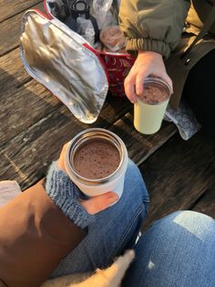 a person holding a cup of hot chocolate