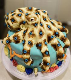 an octopus cake is decorated with blue and brown icing