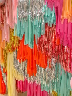 there are many different colored streamers hanging on the wall