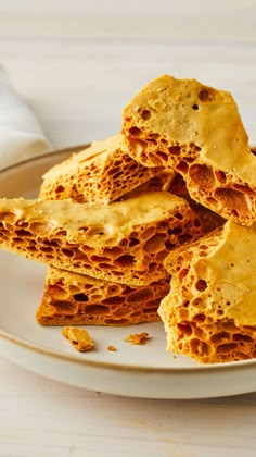 a white plate topped with crackers on top of a table