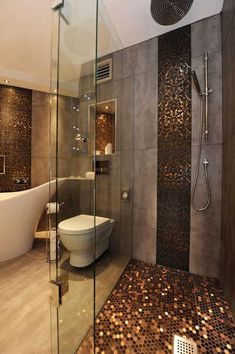 a bathroom with a glass shower door, toilet and bathtub next to each other