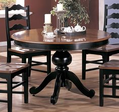 a dining room table with four chairs around it