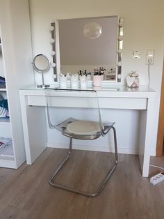 a chair that is sitting in front of a desk with a mirror on top of it