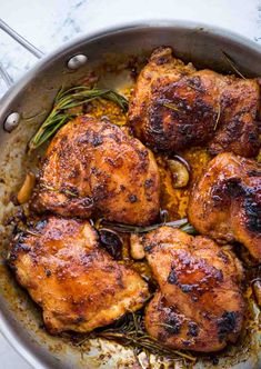 chicken thighs in a pan with herbs and spices