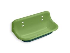 a green sink sitting on top of a white floor