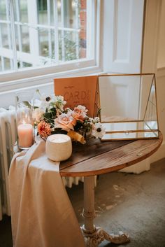 a table with flowers and candles on it