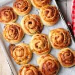 a pan filled with cinnamon rolls on top of a table