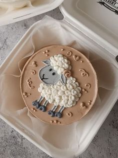 there is a decorated cake in the shape of a sheep on it's side