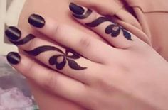 a woman's hands with black and white designs on them