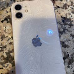 an iphone with the screen cracked off