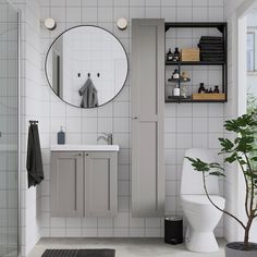 a bathroom with a toilet, sink, mirror and shower stall is shown in this image