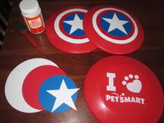 three red plates with white and blue designs on them, one has the word i love petsmart written on it