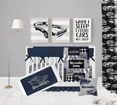 a baby's room with cars on the wall and blue bedding in it