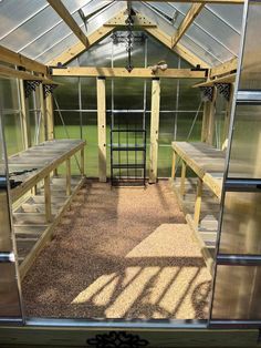 the inside of a greenhouse with lots of windows