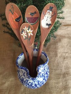 four wooden spoons in a blue and white cup