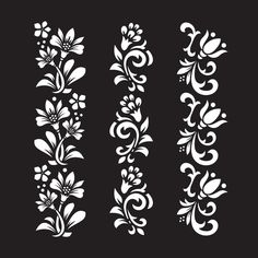 four white floral designs on black background