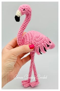 a crocheted pink flamingo is shown in front of a white background