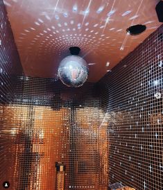 a disco ball hanging from the ceiling in a bathroom