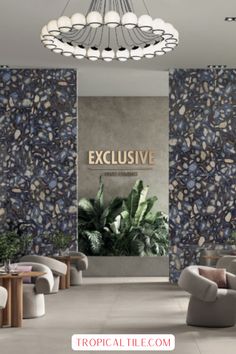 a room with chairs, tables and plants on the wall in front of an exclusive sign that reads tropical tile com