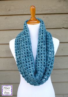 a blue crocheted scarf on a mannequin