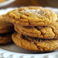 three cookies stacked on top of each other on a white plate with powdered sugar