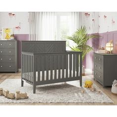 a baby crib in a room with purple walls