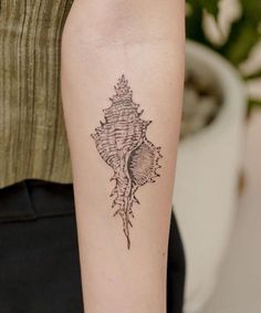 a woman's arm with a tattoo design on the left side of her arm