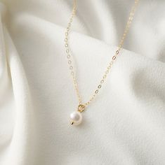 "A single creamy and iridescent pearl - the essence of a classic piece. Dainty and modern, on a on a fine 14K gold fill chain. Pearls symbolize wisdom acquired through experience. The pearl is also said to symbolize the purity, generosity, integrity, and loyalty of its wearer. Pearl is the birthstone for June. *Free shipping for orders to USA and Canada, and no duties and customs fees.* > This pearl is organically shaped so may not be a perfect sphere > Shown worn on a 16\" gold cable chai Popular Necklaces, Pearl Necklace Designs, Iridescent Pearl, Necklace Extender, Pearl Cream, June Birthstone, Girly Jewelry, The Pearl, June Birth Stone