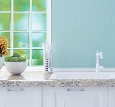 a kitchen counter topped with white bowls filled with flowers