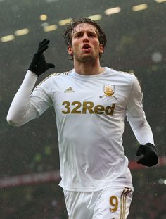 a soccer player is running in the rain