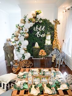 an animal themed birthday party with zebras, giraffes and desserts