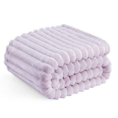 a stack of purple towels on top of each other in front of a white background