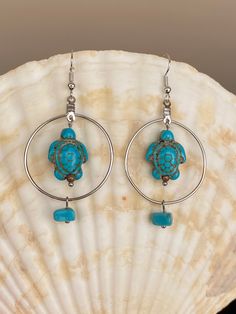 Cute dangle hoop earrings with a turquoise color resin turtle; Silver tone ear wire and hoop; Smoke-free, pet-free studio; Comes in a gift box, ready for gifting Resin Turtle, Blue Turtle, Color Resin, Easy Handmade, Diy Jewelry Unique, Earring Designs, Dangle Hoop Earrings, Beaded Earrings Patterns, Earring Ideas