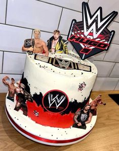 a birthday cake decorated with wrestling figures