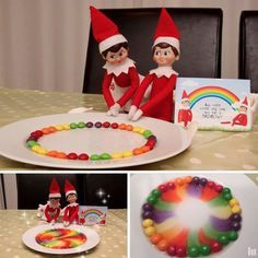 two elfs are sitting at the table with candy and an image of a rainbow cake