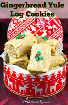 gingerbread yule log cookies in a red and white tin with christmas decorations on it