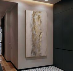 an abstract painting hangs on the wall next to a tiled floor